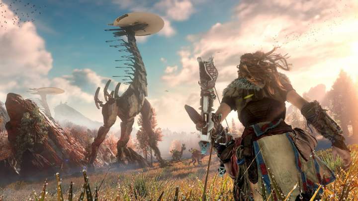 Aloy running towards a Tallneck with her bow and arrow.