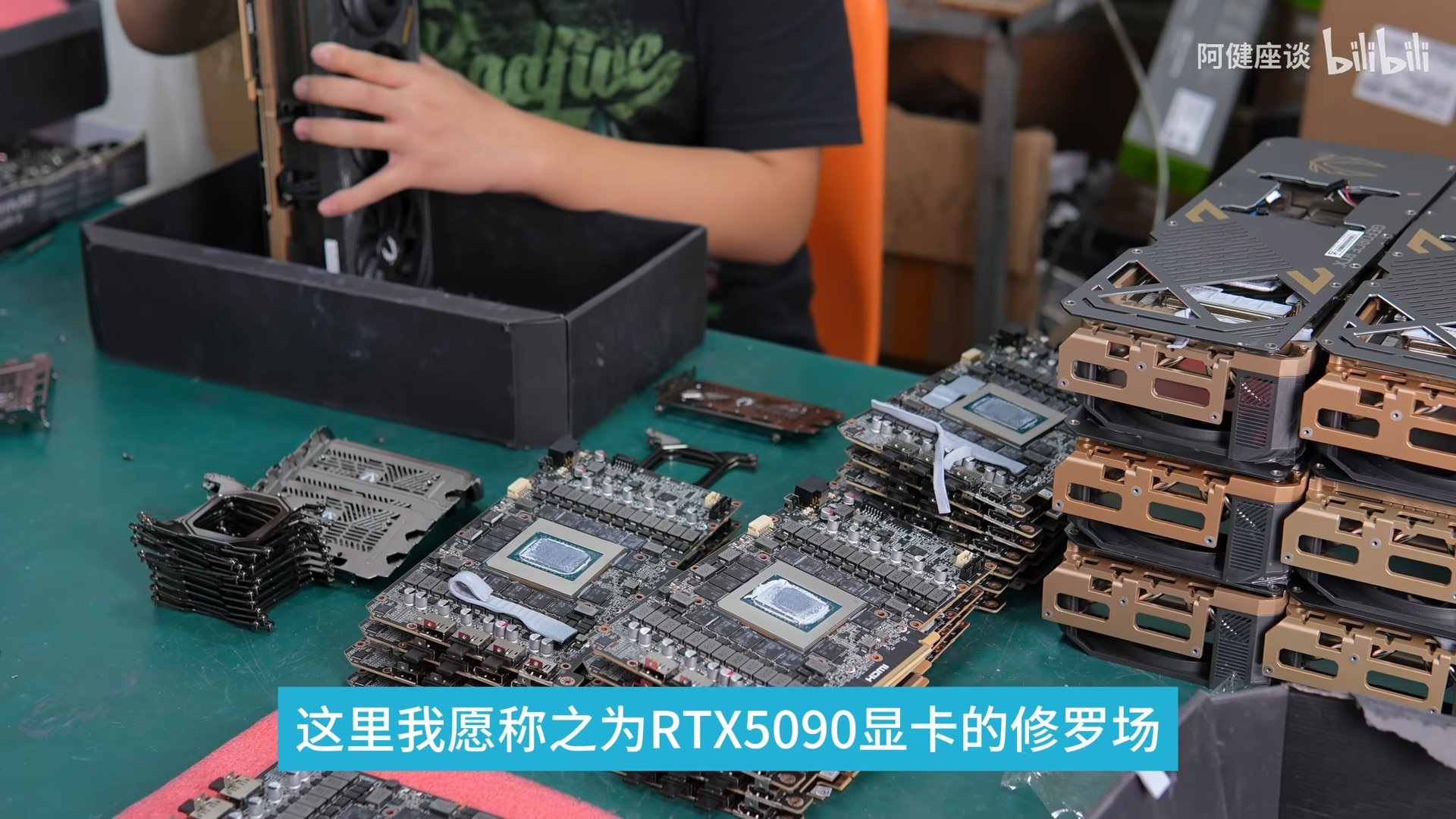 Person assembling graphics cards in workshop, tech repair scene.