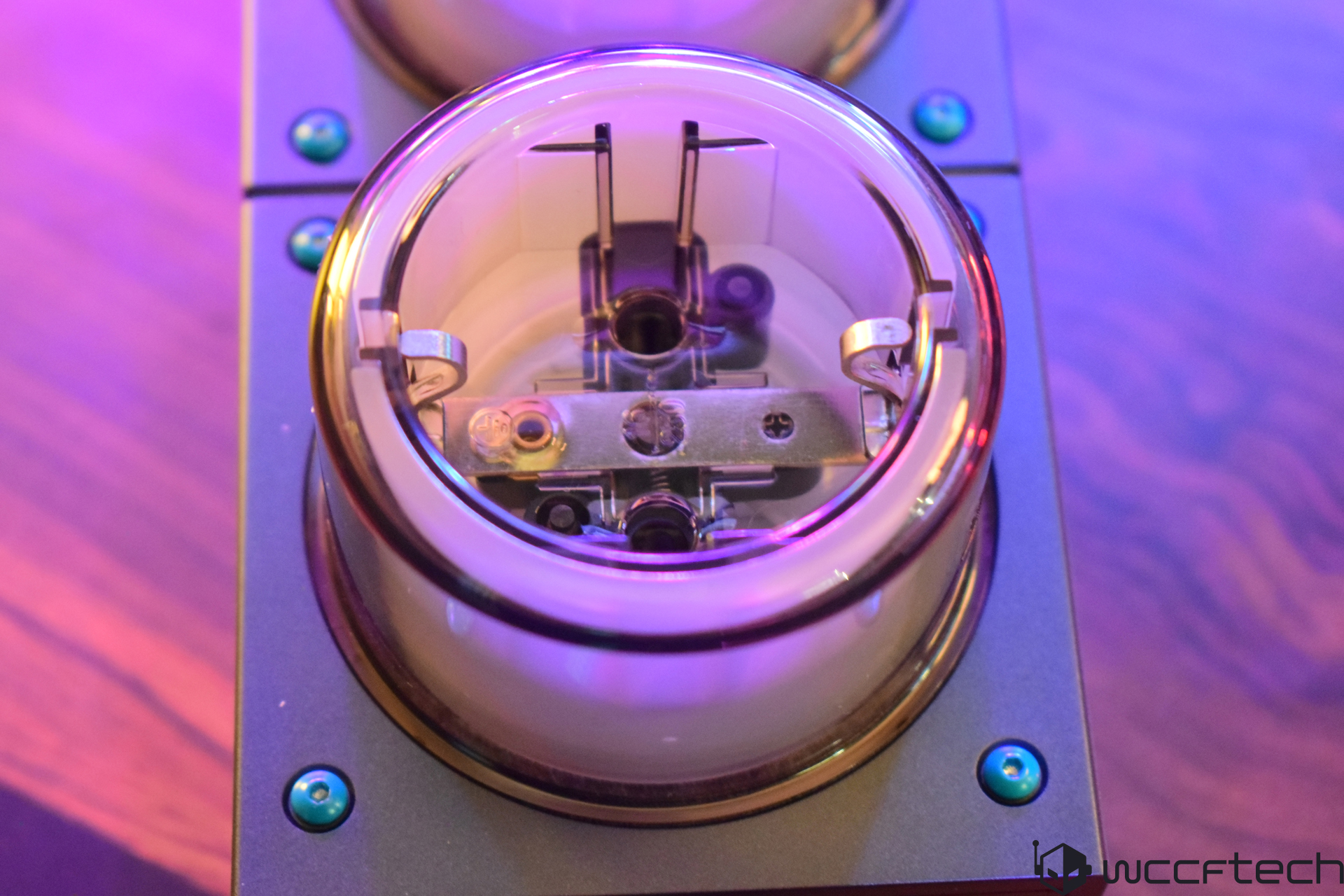 Close-up of a tech gadget component with purple lighting, showcasing intricate internal design.