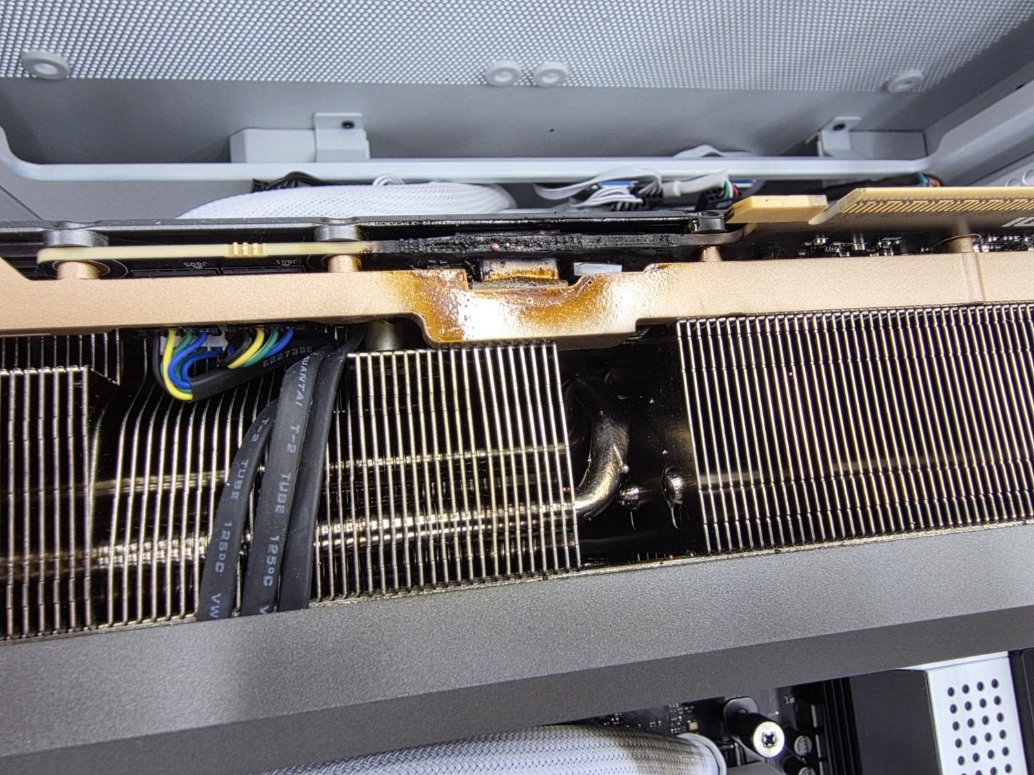 Close-up of a computer component with visible liquid residue and exposed wiring.