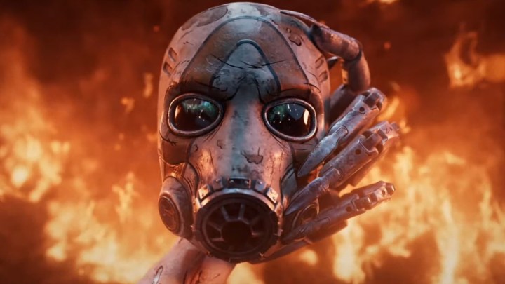 Un masque psycho de Borderlands tenu devant une tonne de flammes.