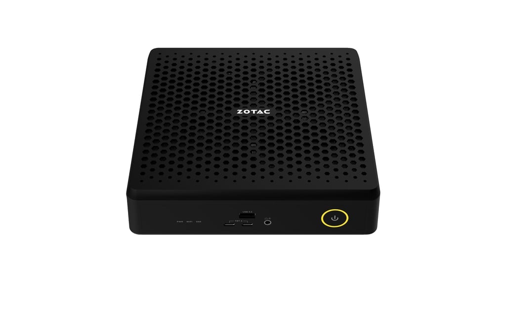 Zotac mini PC with a perforated design and a yellow-bordered power button on the front panel.