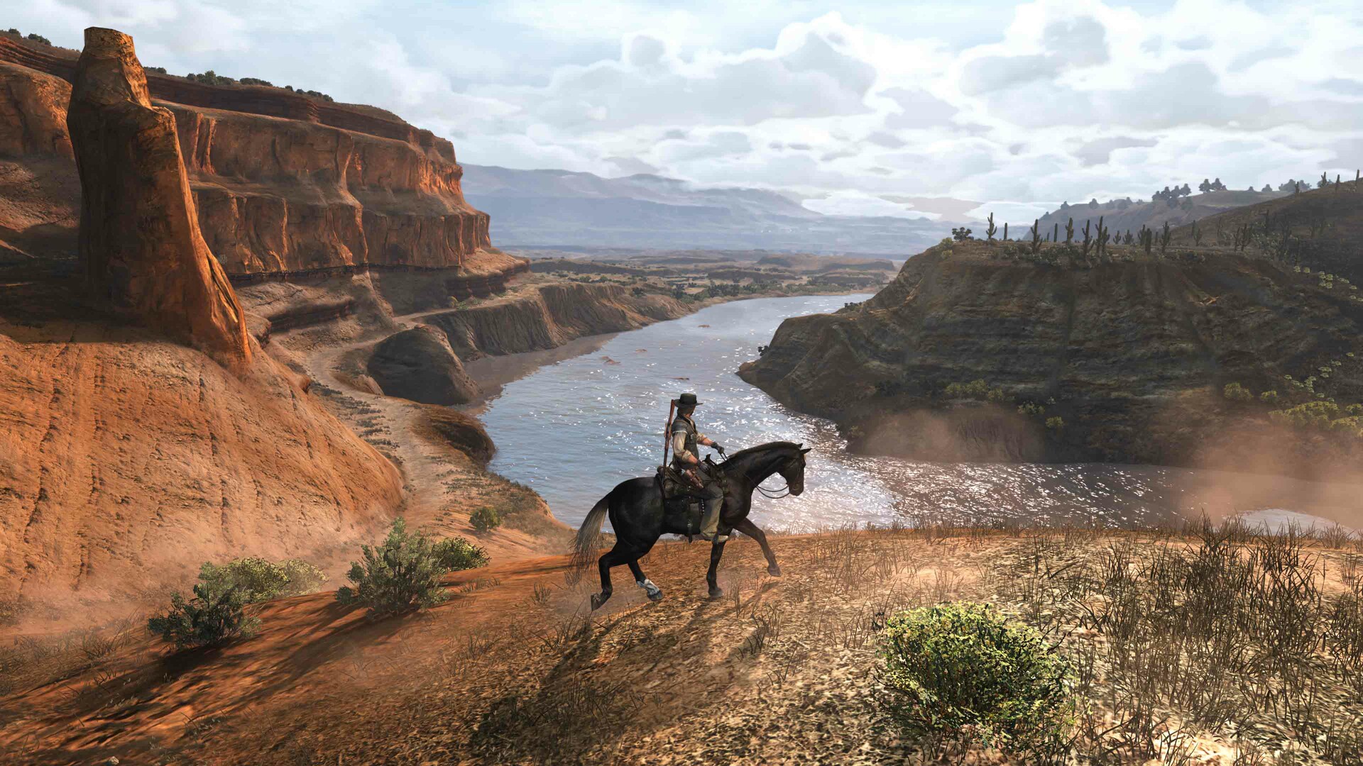 Un personnage à cheval explorant un canyon dans le jeu 'Red Dead Redemption'.