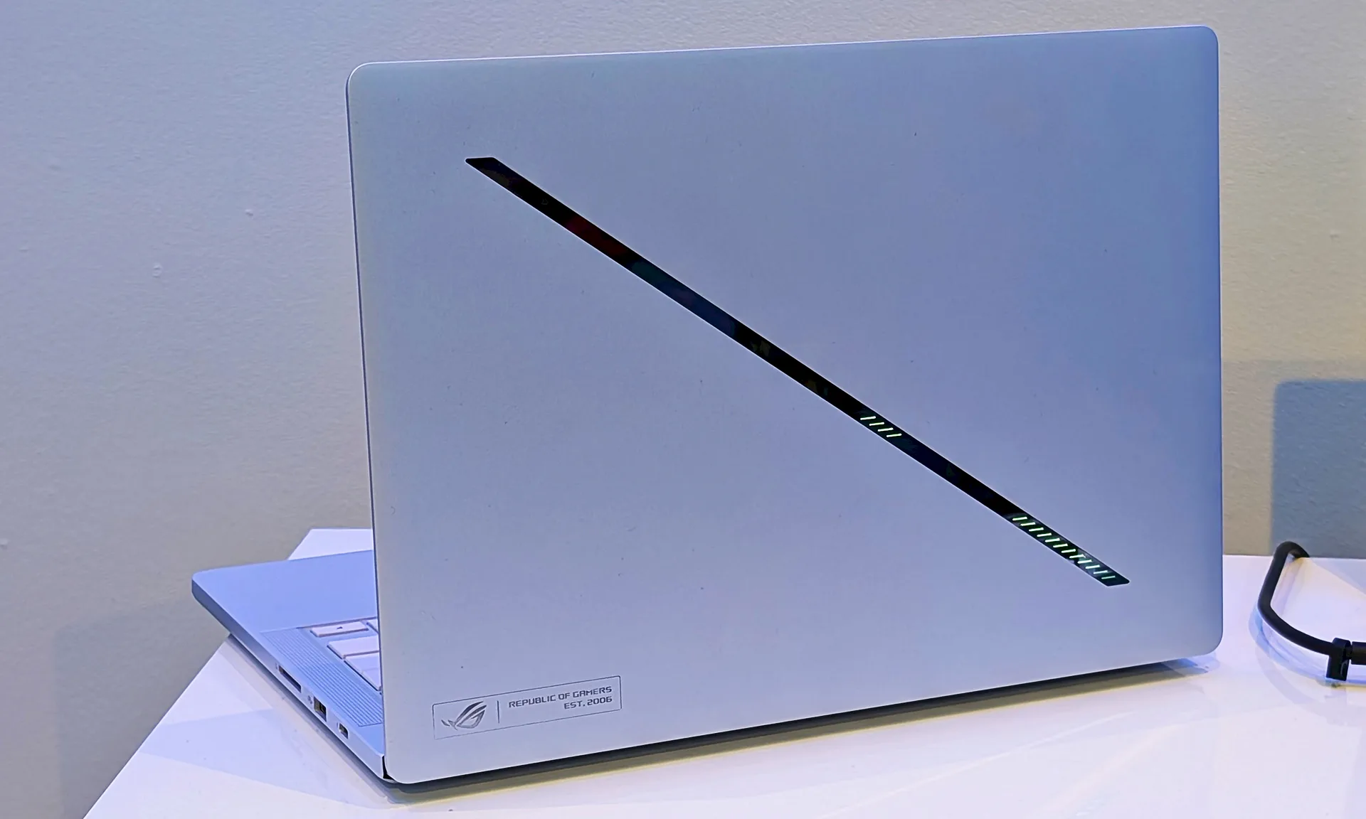 Asus Zephyrus G14 2026 sitting on a white desk with its lid open and facing the camera.