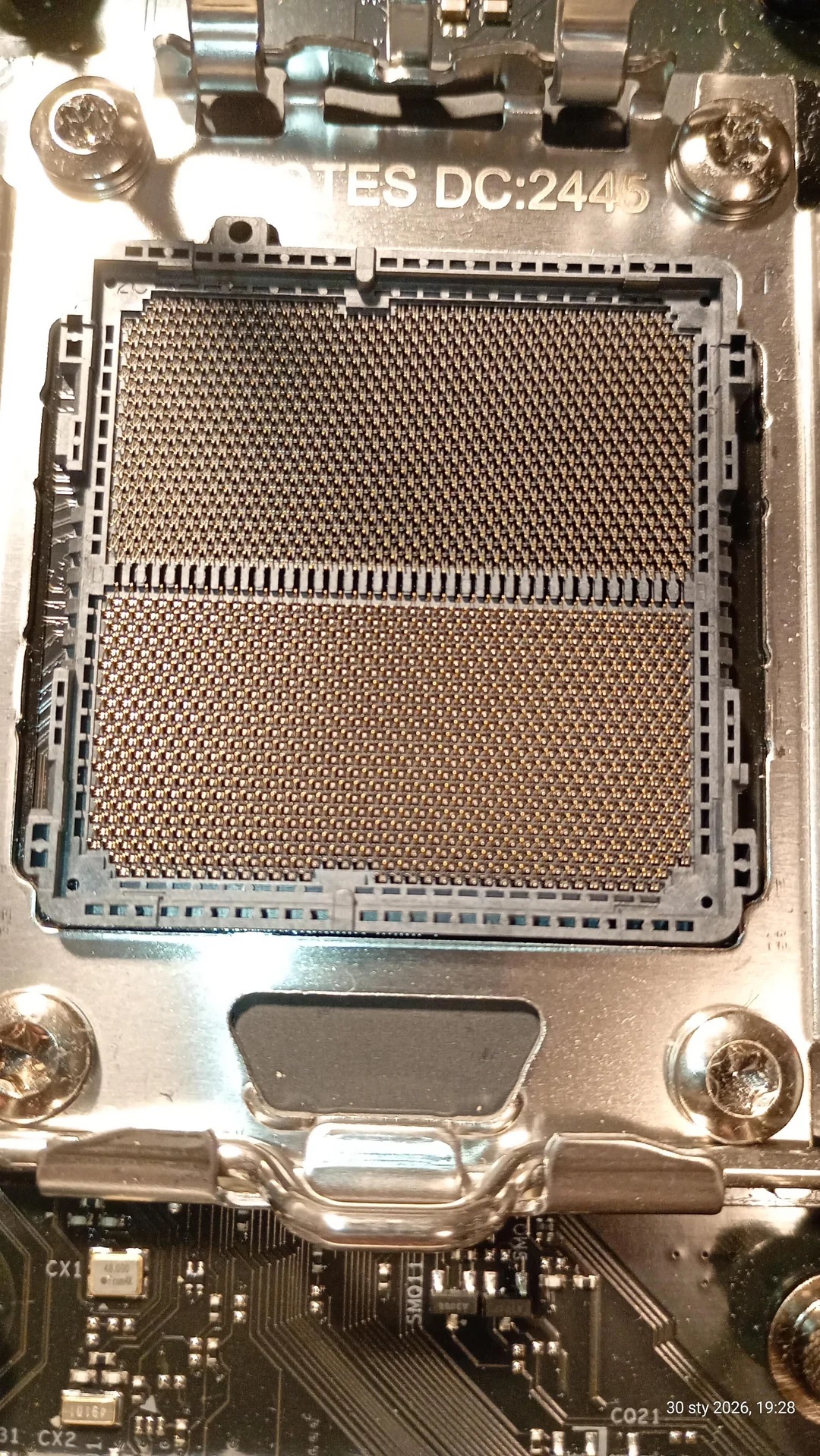 Vue rapprochée d'un socket CPU Intel LGA 4677 sur une carte mère étiquetée 'TES DC:2445'.