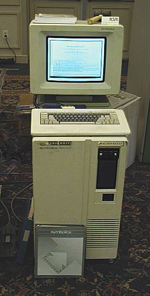 A Symbolics 3640 workstation with a CRT monitor displaying text, a keyboard, and the model name 'Symbolics' visible on the front panel.