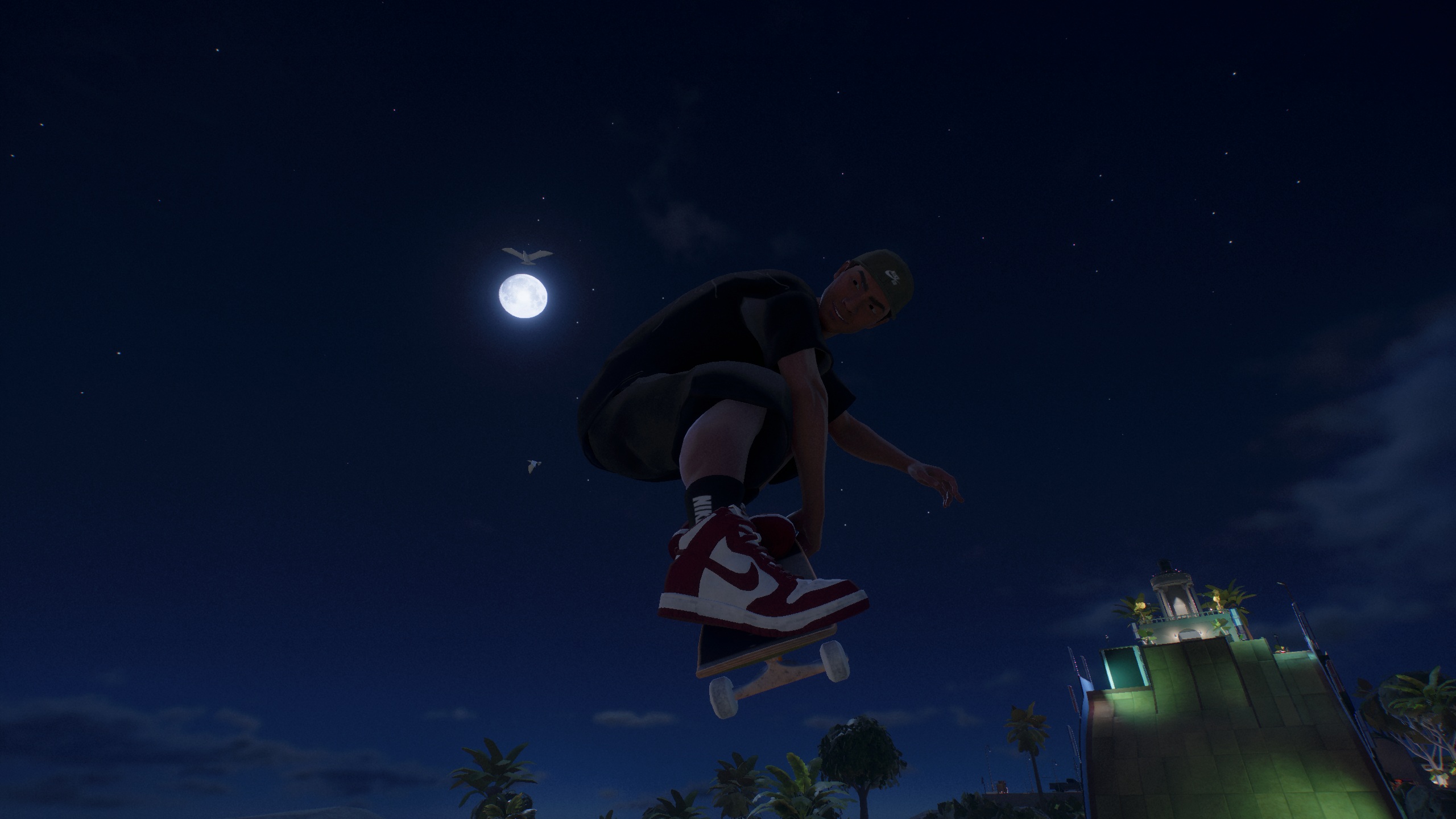 A character in 'Skate' performing a mid-air trick under a full moonlit night sky with a lighthouse in the background.