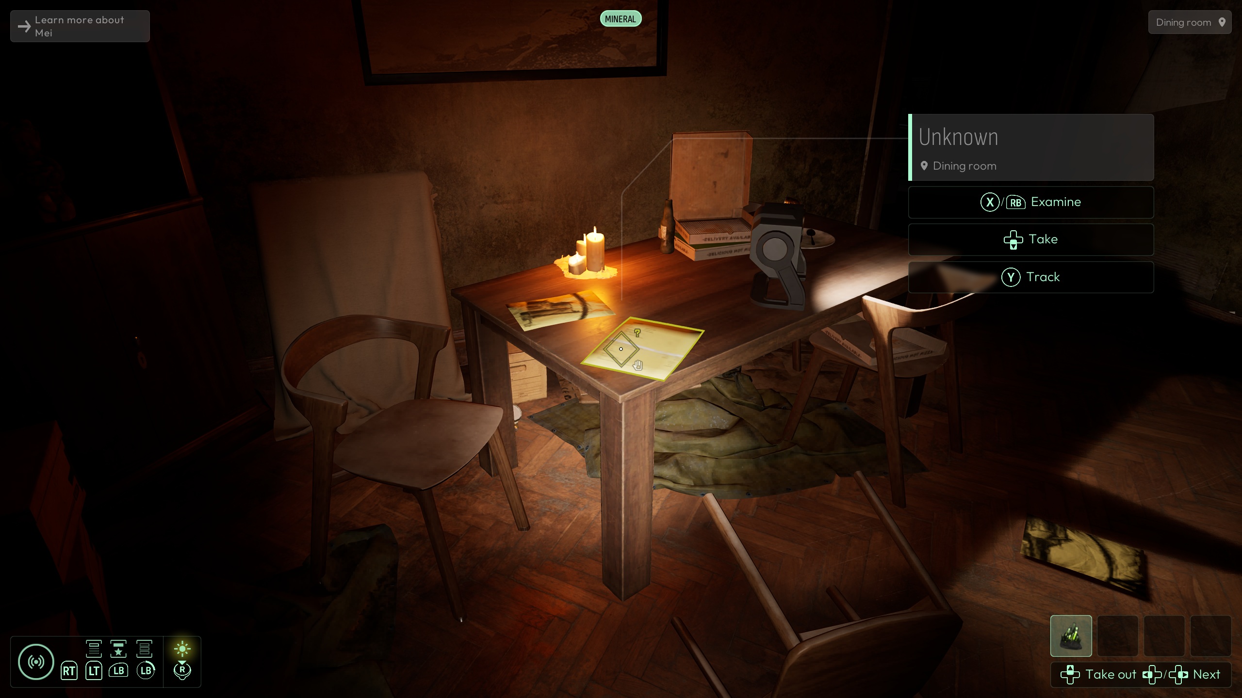 A dimly lit room in a video game shows a wooden table with candles, a notebook, and a device on it, while an on-screen menu offers the options to 'Examine,' 'Take,' or 'Track' an 'Unknown' item in the 'Dining room.'