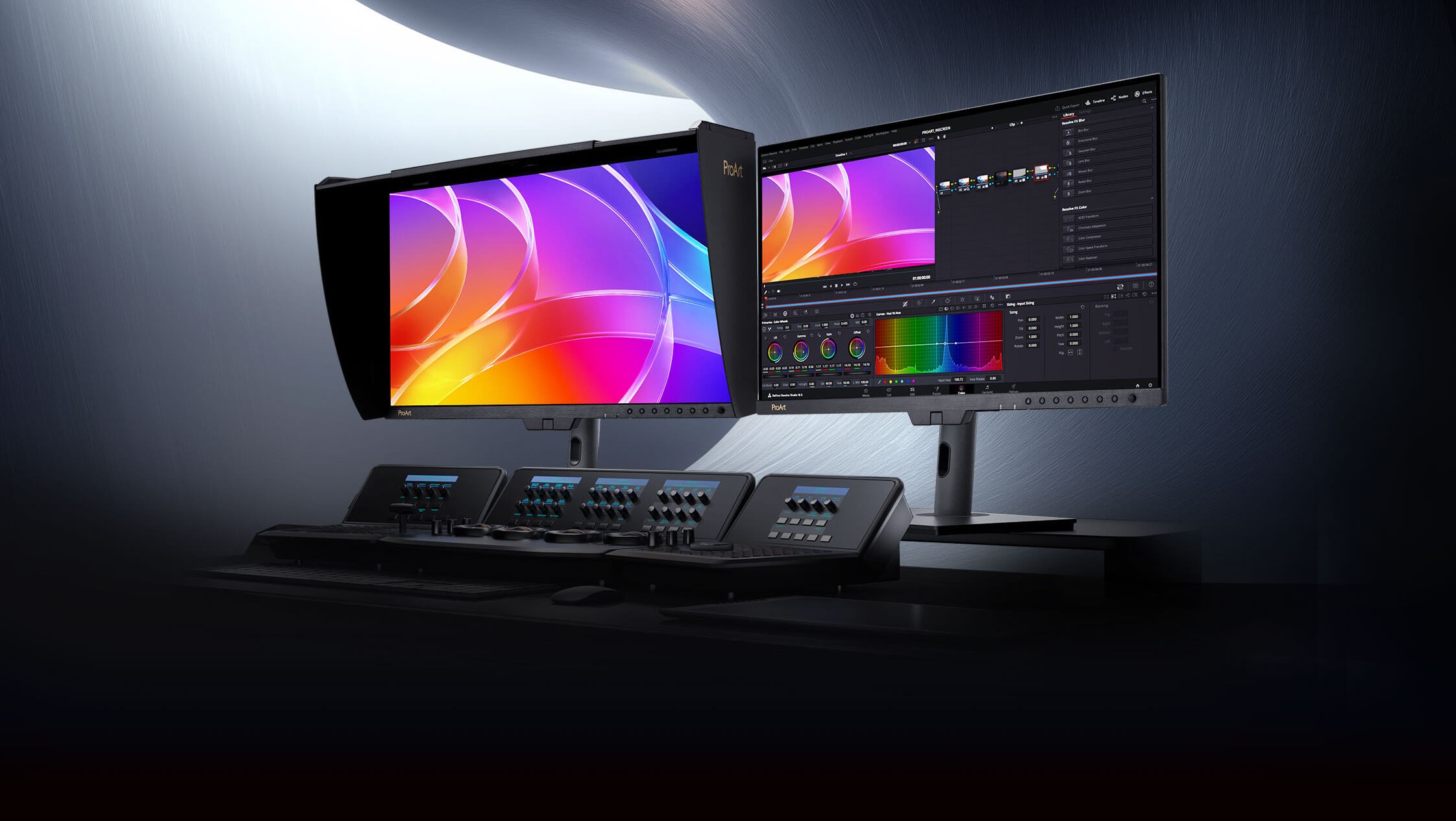 Two ASUS ProArt monitors are displayed, one showing vibrant abstract graphics and the other a video editing software interface with color grading tools.