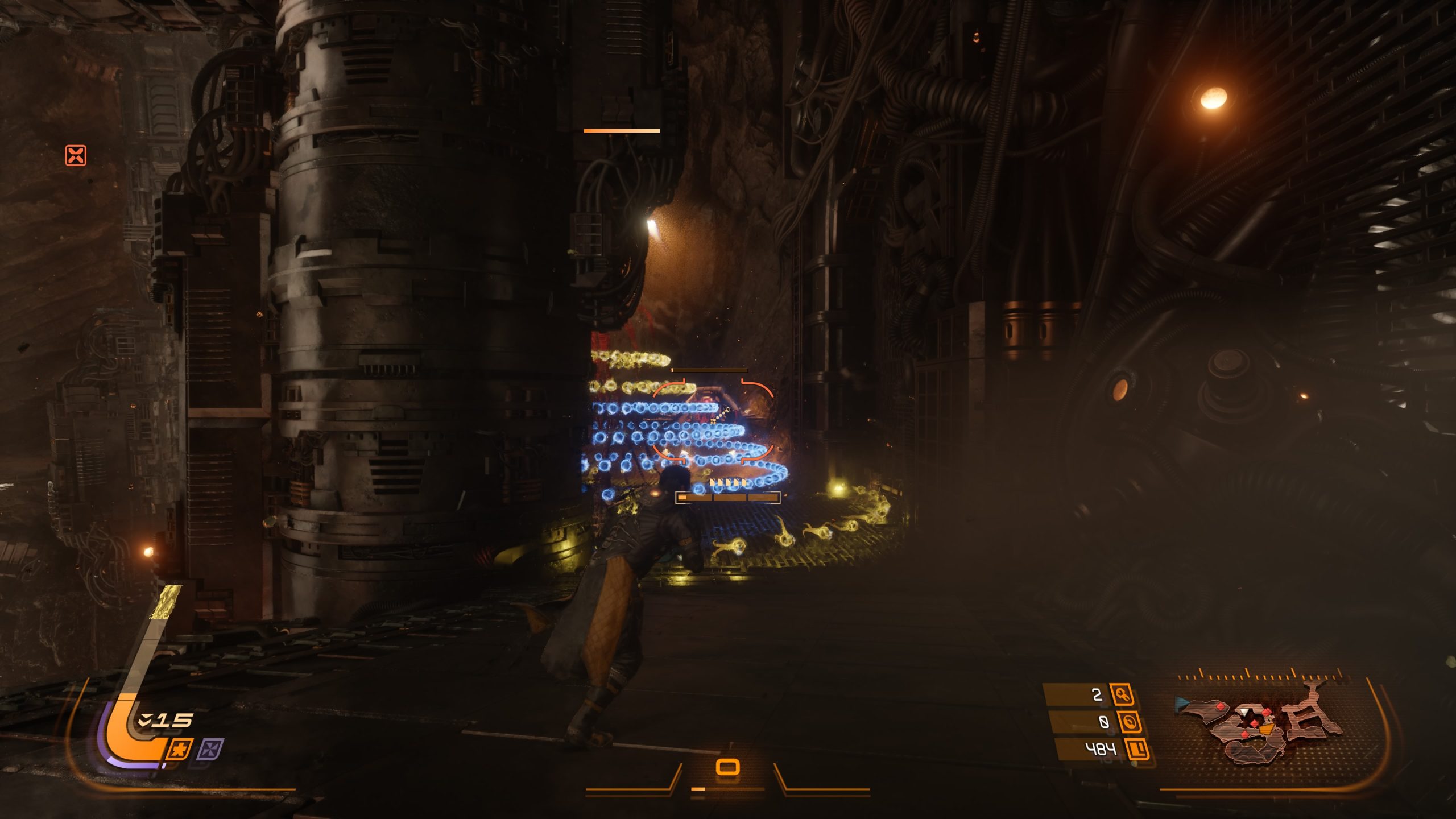 A character in a dimly lit, industrial setting in the game Saros stands near a spiral of glowing blue and yellow orbs, with a user interface displaying '15' in the corner.
