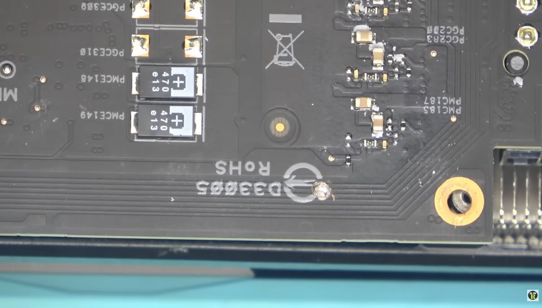 Close-up of a circuit board featuring various components and connectors with printed identifiers including 'PCG330' and 'R0HS'.