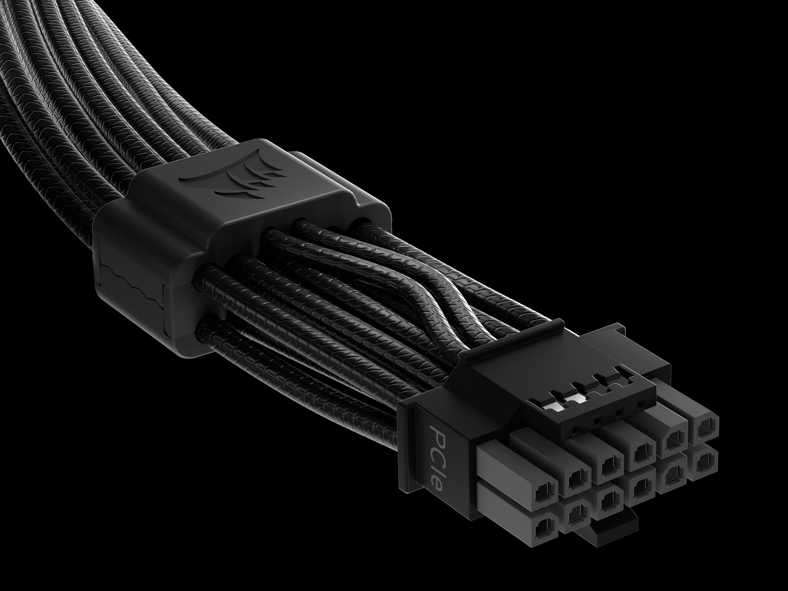 A close-up of a black PCIe power connector with braided cables and a stylized emblem on the cable comb.
