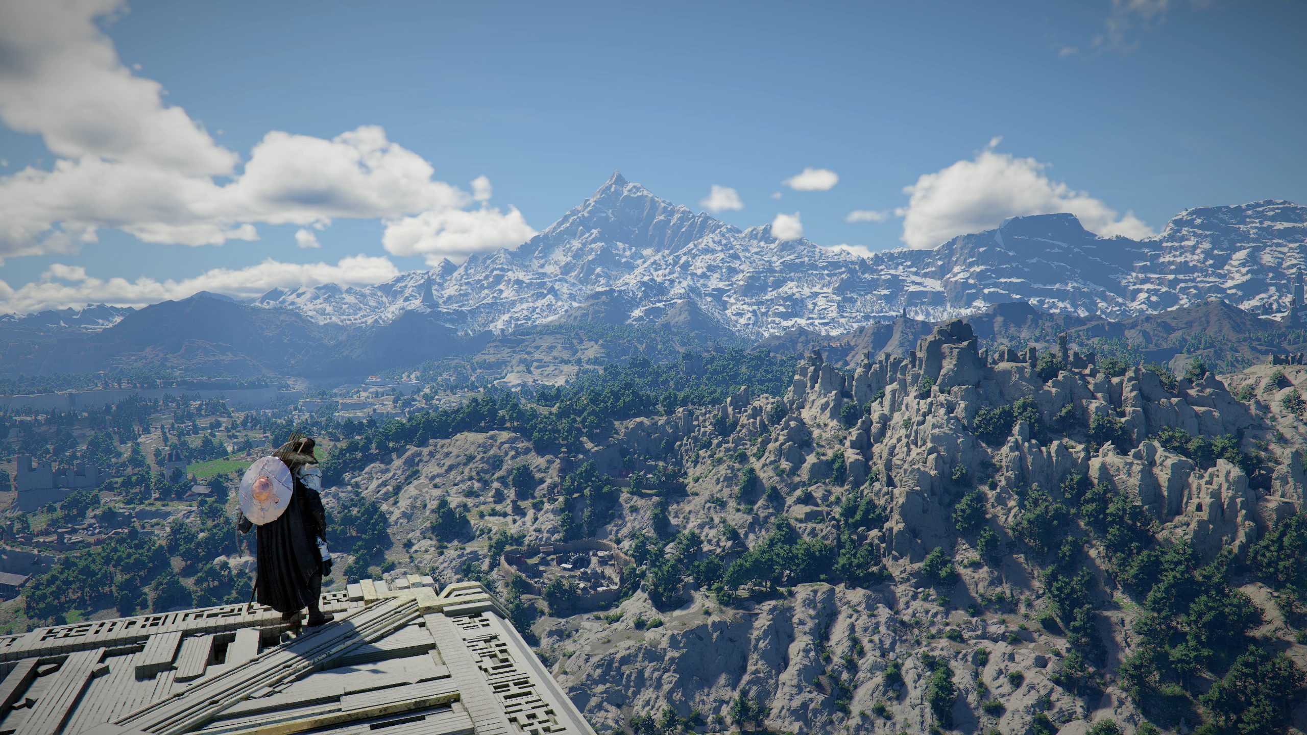 A character in Crimson Desert standing on a wooden platform overlooking a vast landscape with snow-capped mountains and lush green forests.
