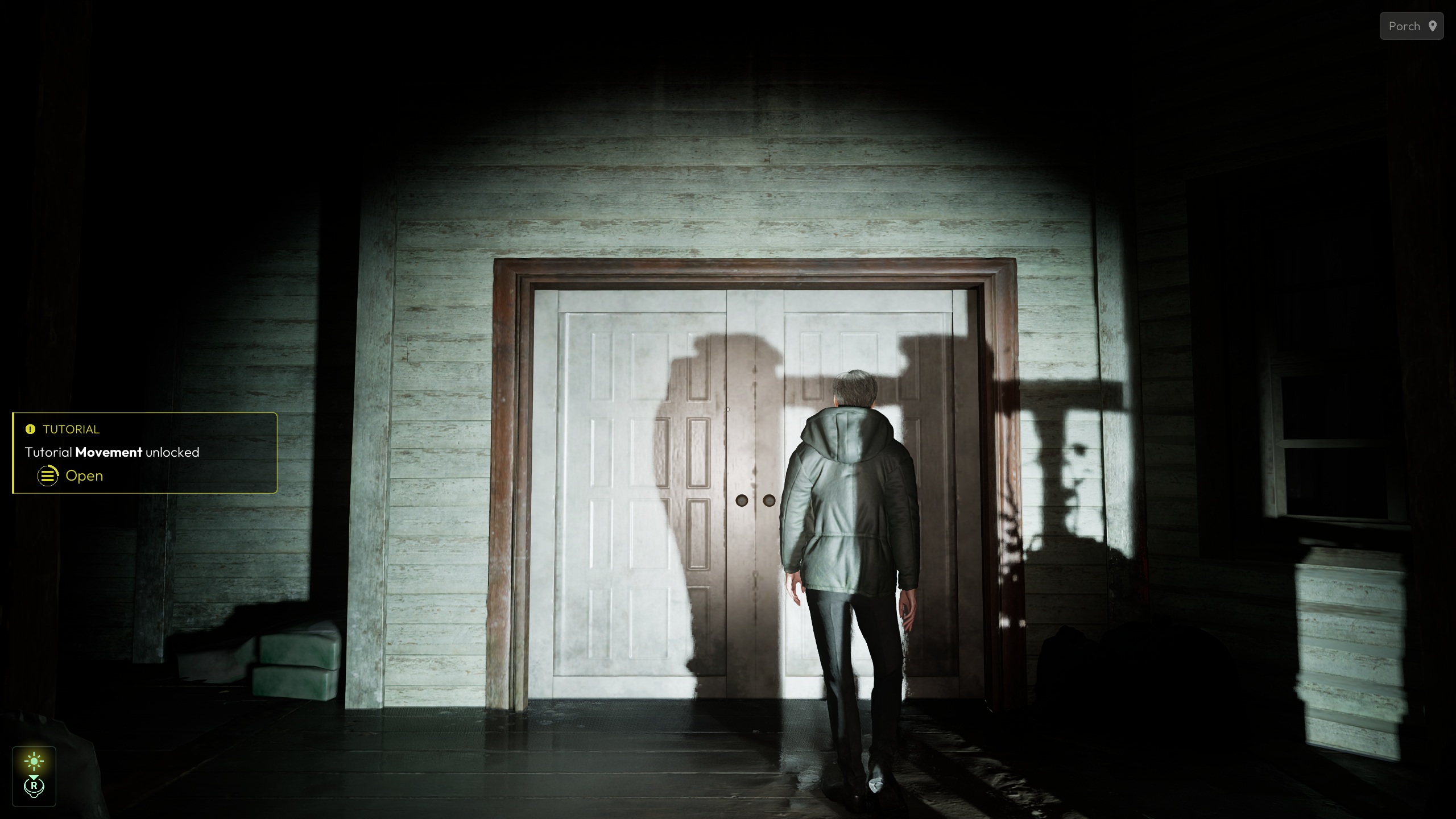 A character in a dark setting stands in front of closed double doors, with a 'Tutorial Movement unlocked' message displayed on the left.