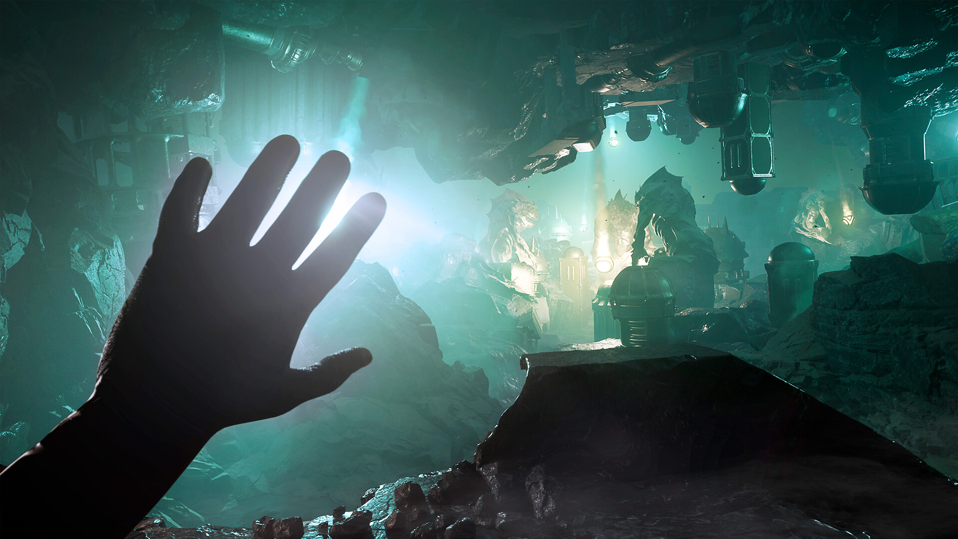 A hand reaches towards a glowing, rocky underground environment with mechanical structures in a scene from a video game.
