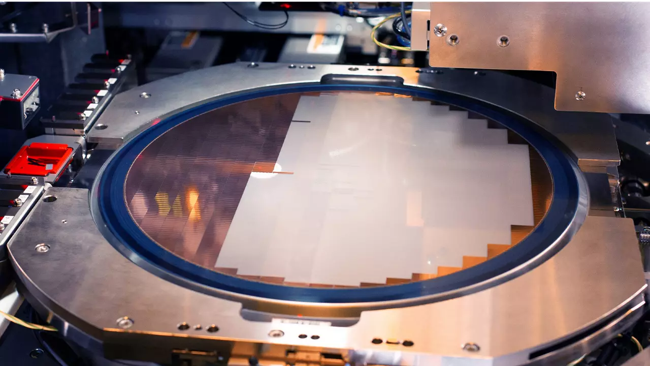 A close-up view of a silicon wafer on a semiconductor fabrication machine.