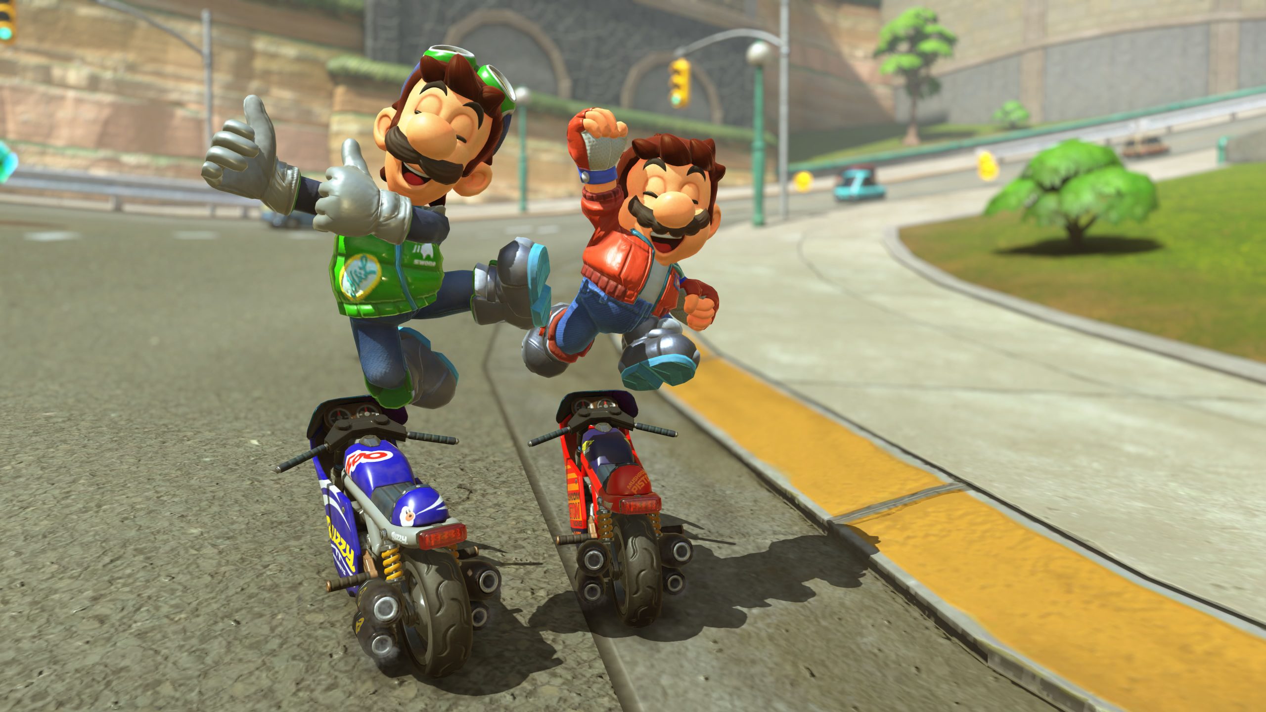 Two characters race on motorcycles in the game Mario Kart, performing a celebratory jump on a curved track.