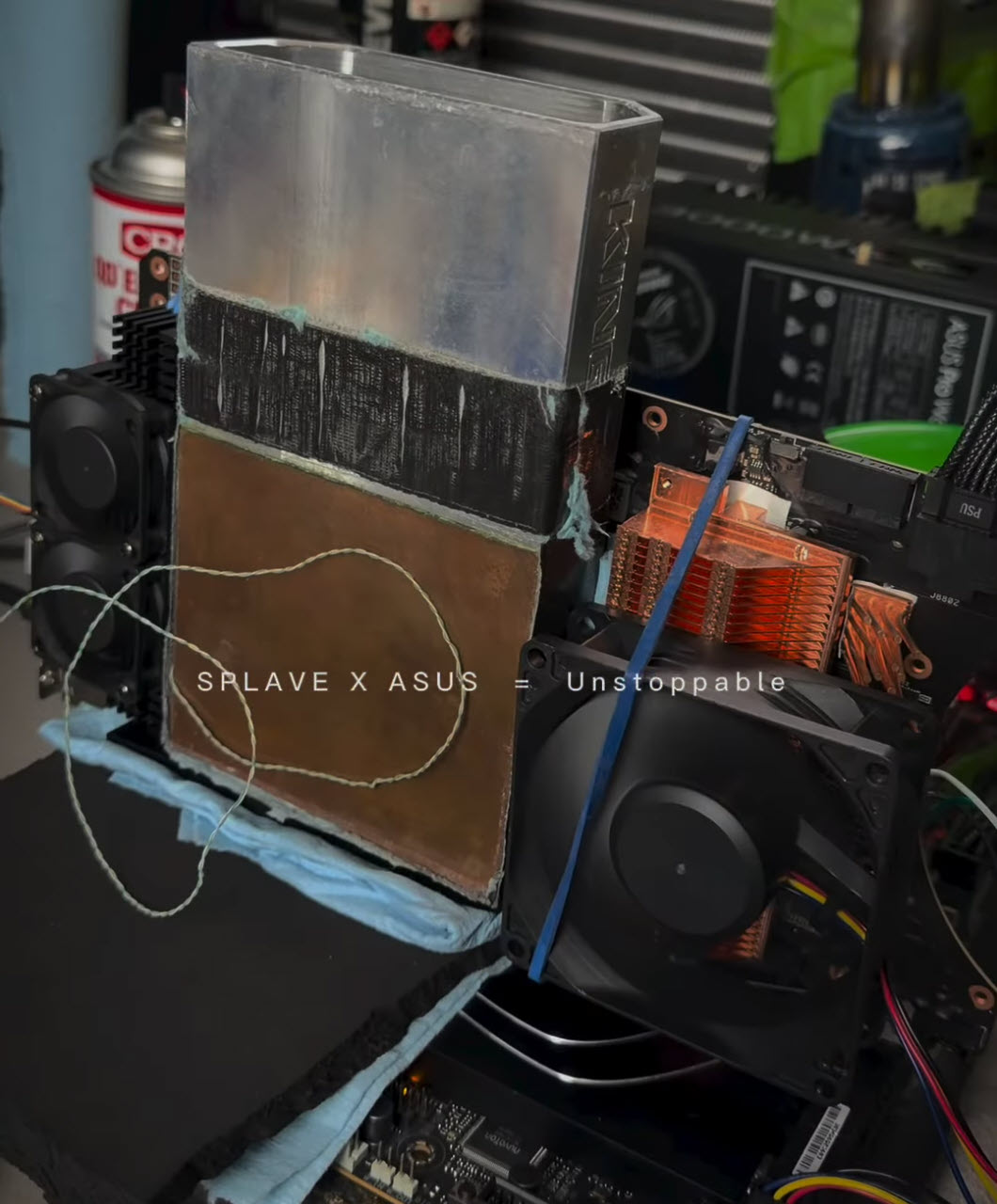 A custom cooling setup for an ASUS motherboard is branded with 'SPLAVE X ASUS – Unstoppable' and features large heatsinks, fans, and visible wiring.