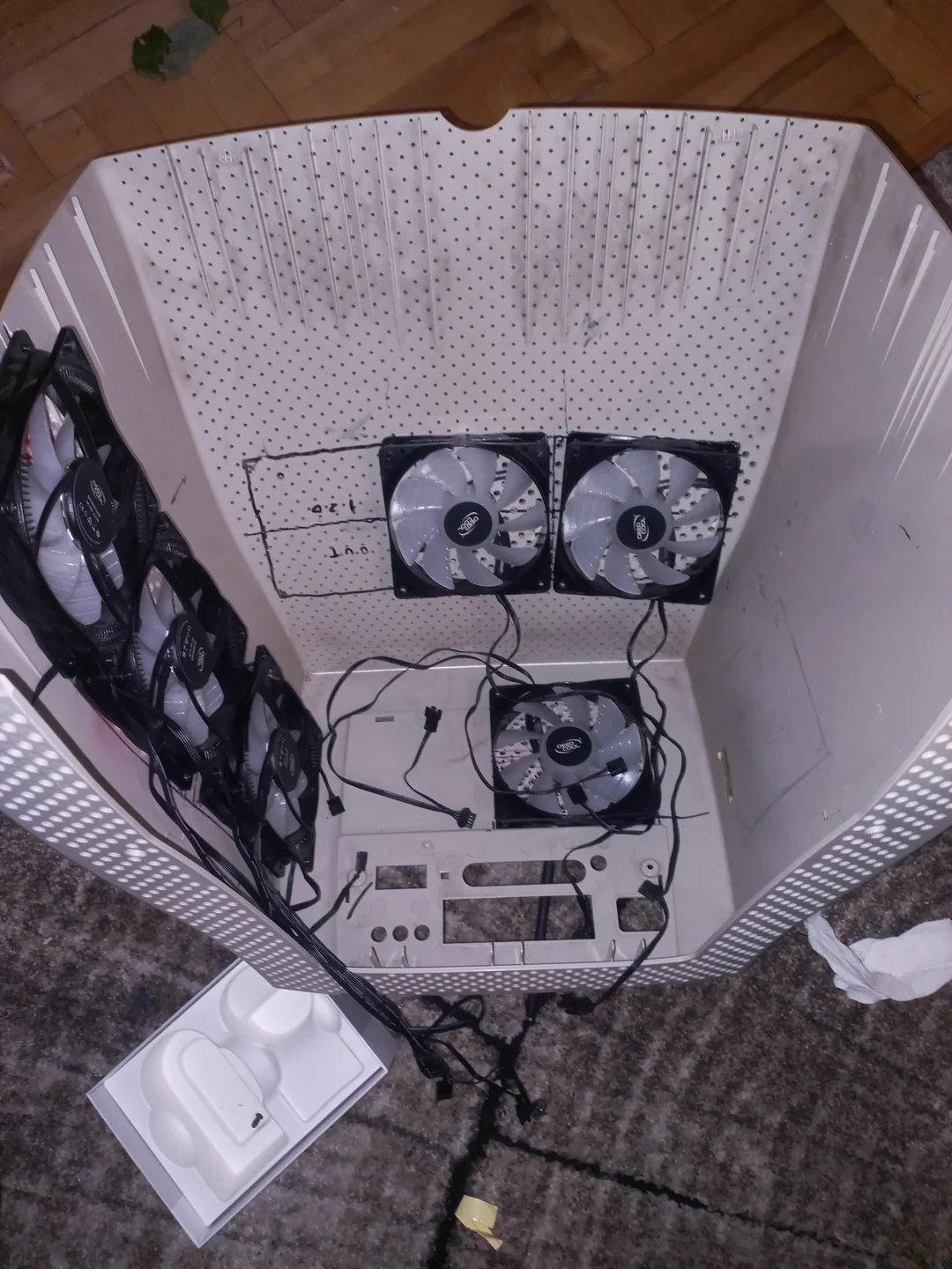 A white plastic enclosure modified with mounted Deepcool fans on its sides, with visible cables inside.