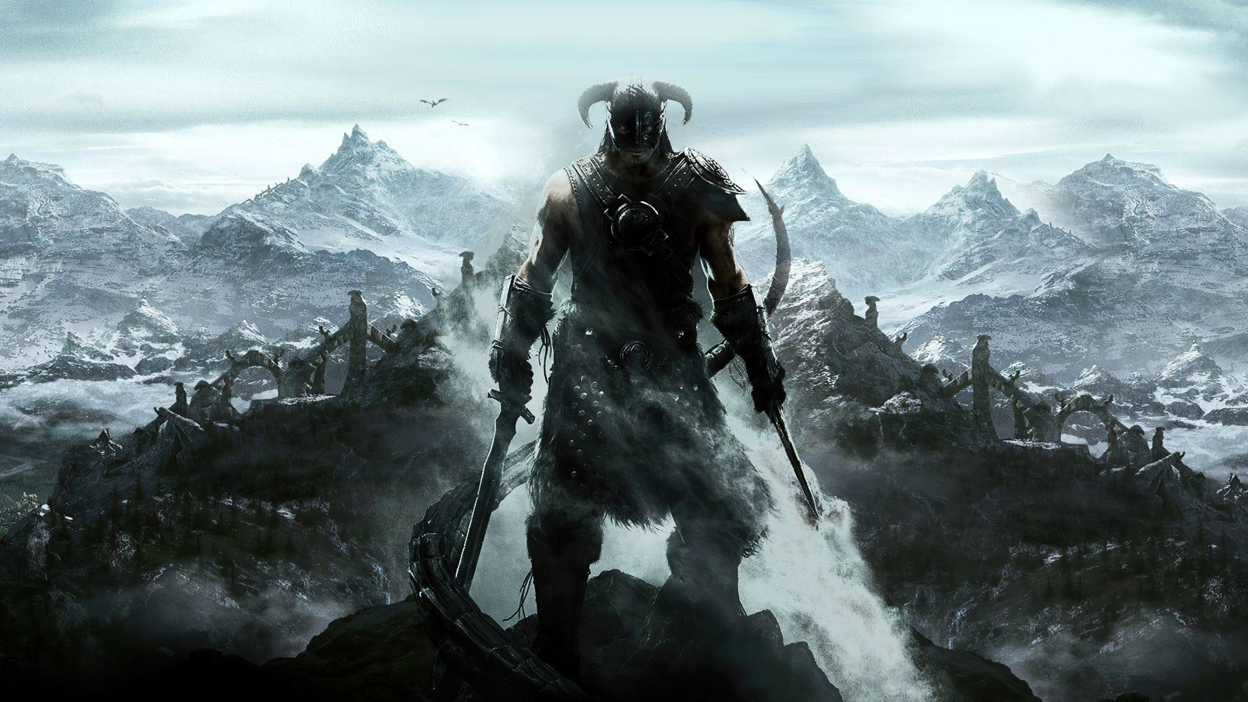A character from The Elder Scrolls V: Skyrim stands on a mountain with snow-covered peaks and ancient ruins in the background.