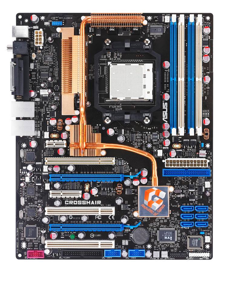An ASUS Republic of Gamers Crosshair motherboard with multiple PCIe slots, blue RAM slots, and visible copper heat pipes.