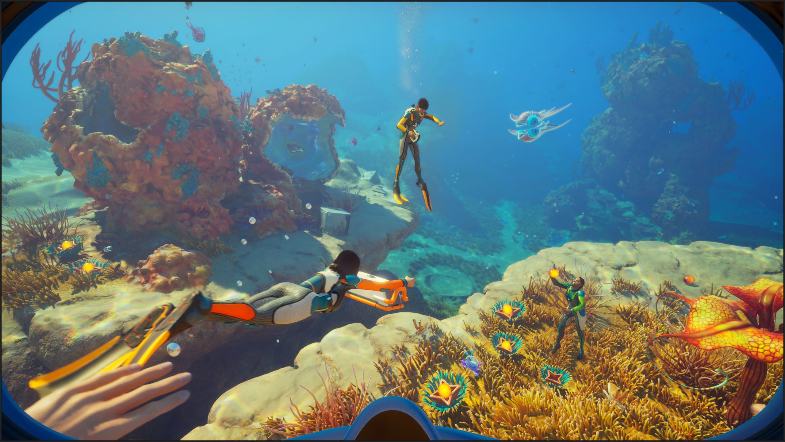 A player in the game 'Subnautica 2' explores an underwater landscape with colorful coral and aquatic plants, accompanied by two other divers.