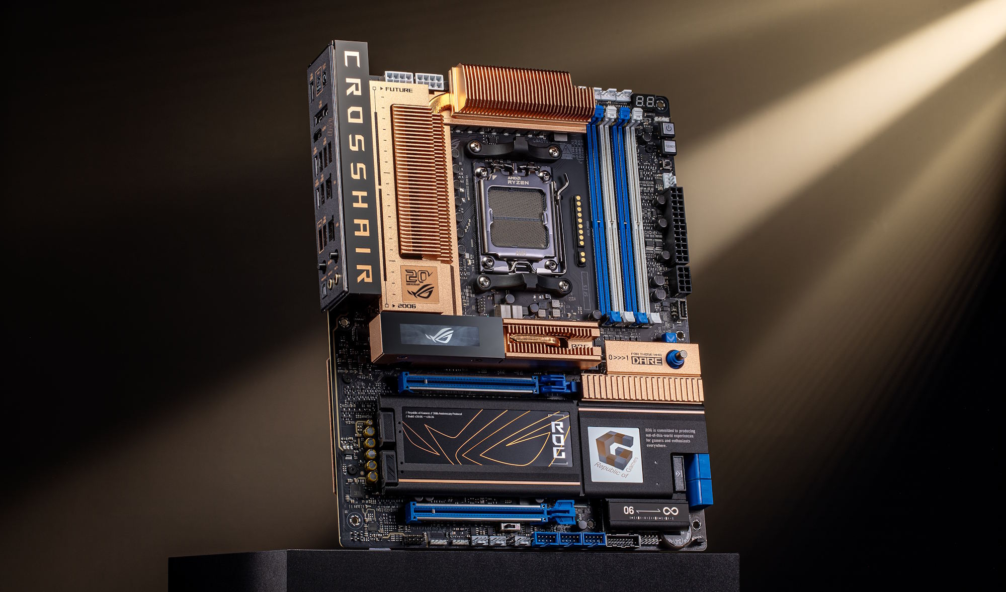 An ASUS ROG Crosshair motherboard with prominent cooling fins and visible branding is displayed under a spotlight.