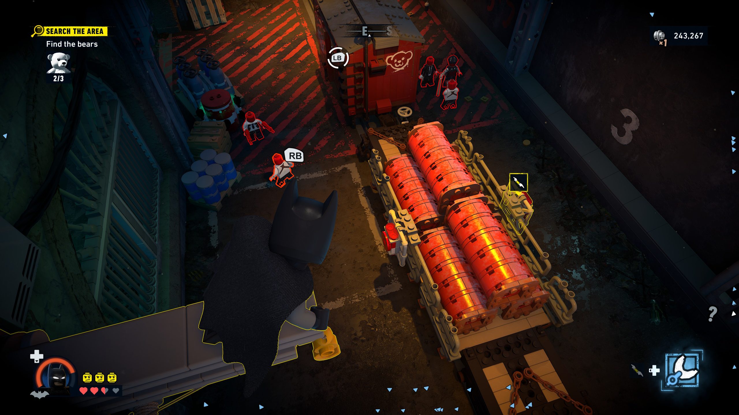 Batman LEGO explore un décor industriel, objectif 'Trouver les ours' et interface visibles.