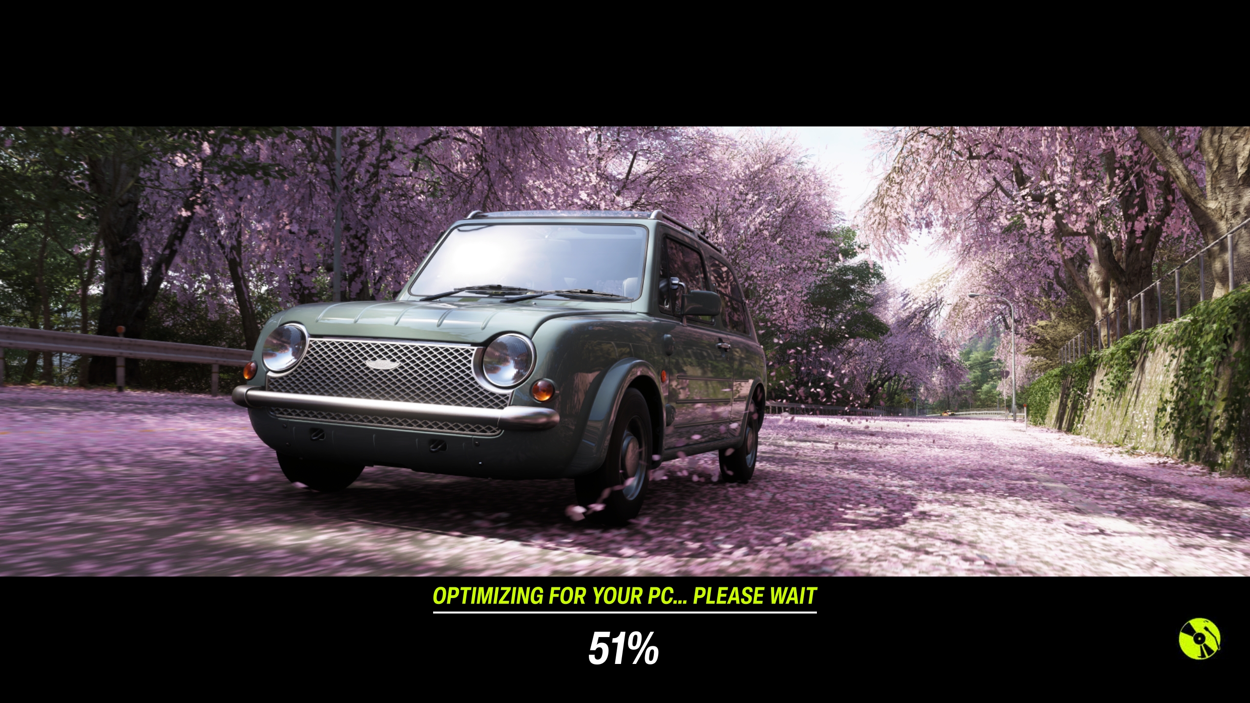 Une voiture ancienne roule parmi des pétales de cerisier avec le texte à l'écran 'OPTIMISATION POUR VOTRE PC... VEUILLEZ PATIENTER 51%'.