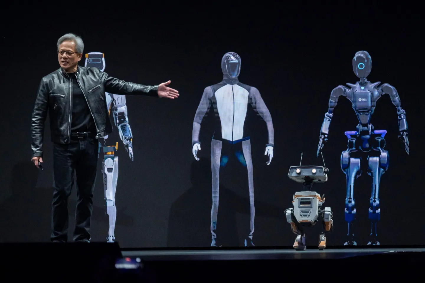 Presenter showcases futuristic robots on stage.