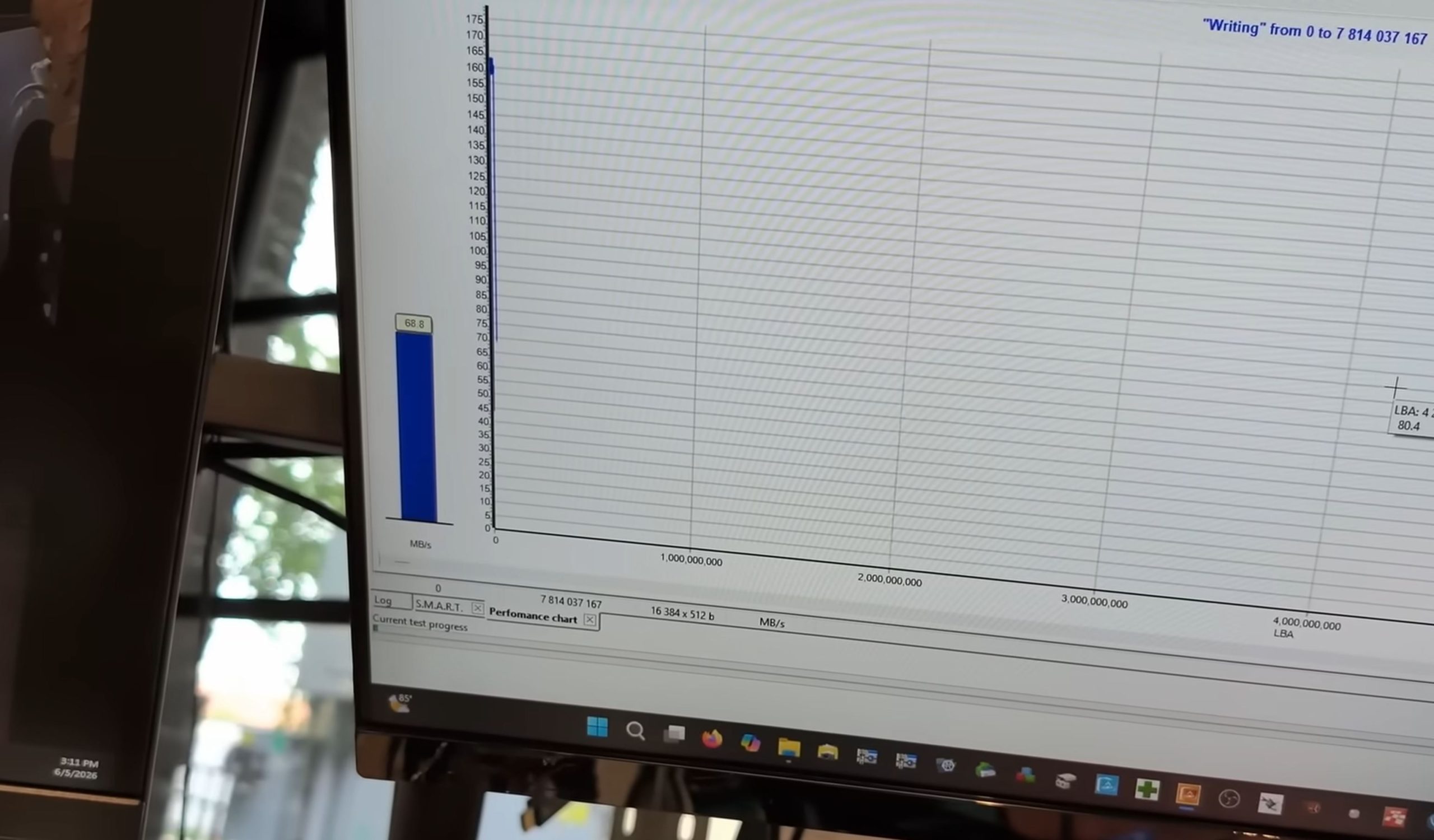 Un graphique de performance sur un écran d'ordinateur affiche une vitesse d'écriture de 68,8 Mo/s avec le titre 'Writing' de 0 à 7 814 037 167.