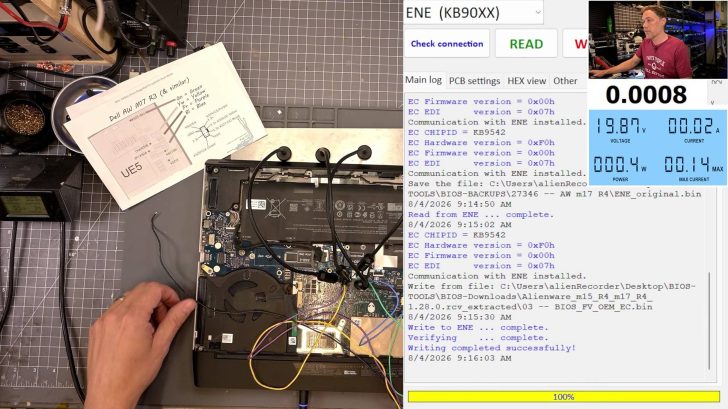 A Dell AW m17 R3 laptop is being tested on a workbench, connected to a software interface displaying voltage and current readings, with the text 'Writing completed successfully!' on the screen.