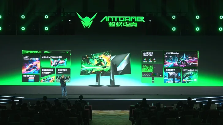 A presenter on stage showcases Antgamer monitors with specifications like 'UHD 240Hz,' '0.03ms response time,' and 'DisplayHDR 400.'