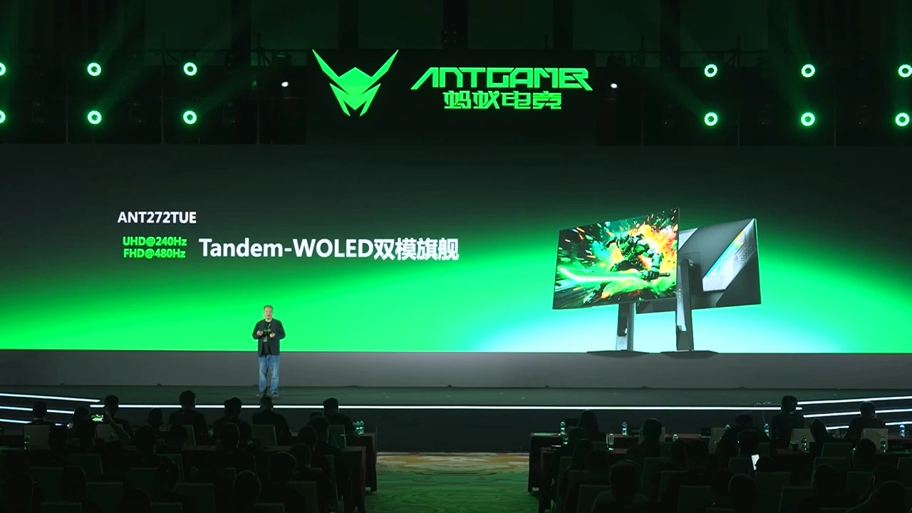 A presenter on stage showcases the ANT272TUE monitor with 'Tandem-WOLED' technology, featuring UHD@240Hz and FHD@480Hz, under the AntGamer brand logo.