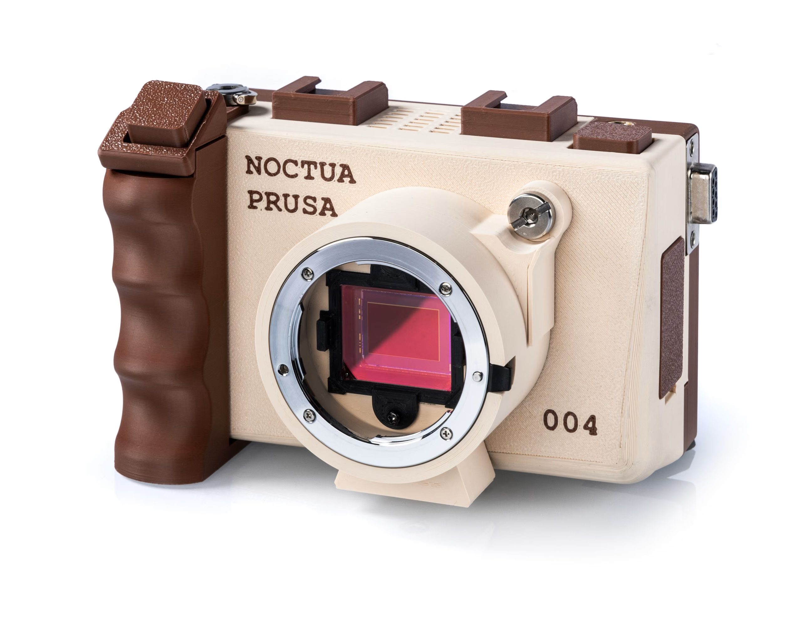A Noctua Prusa camera with 004 marked on the side, featuring a visible digital image sensor and a brown grip design.