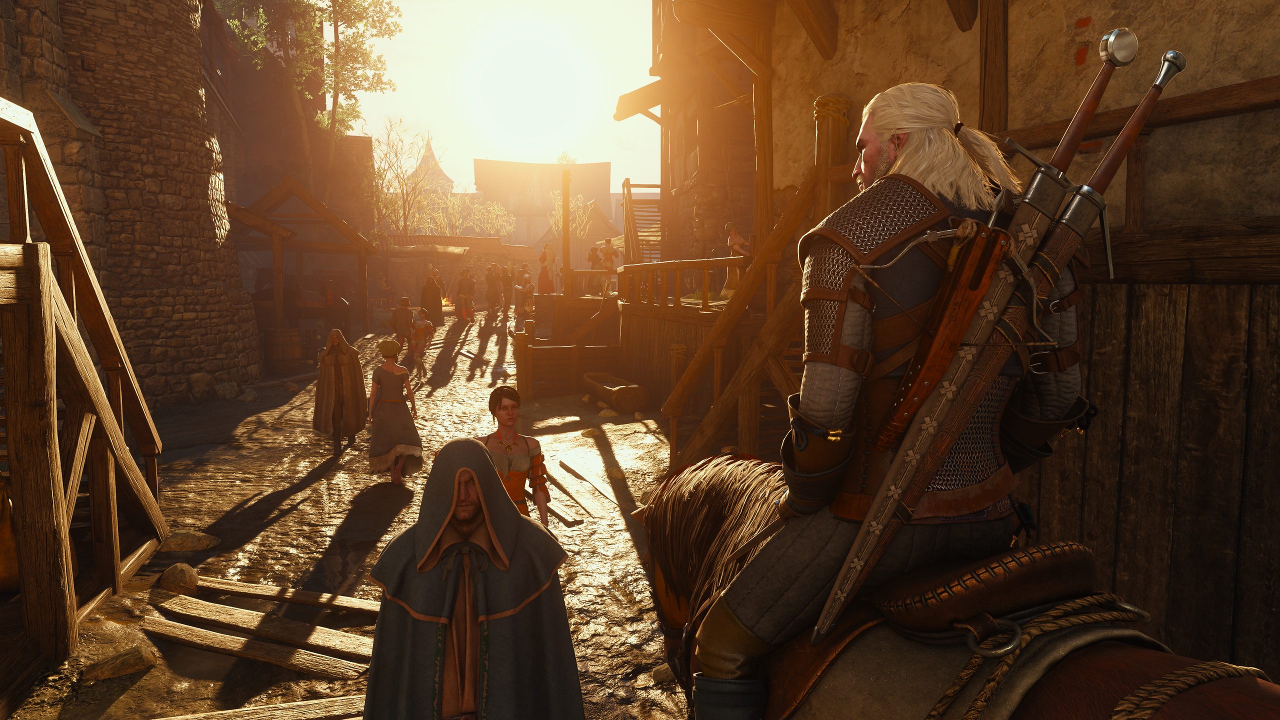 Geralt of Rivia on horseback rides through a sunlit medieval town in The Witcher 3: Wild Hunt - Remastered.
