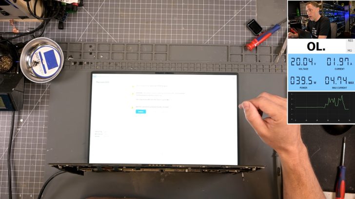 A Dell Precision 5550 laptop is on a workbench with a screen displaying system warning messages alongside a power analysis tool showing '39.5 W' and '20.04 V'.