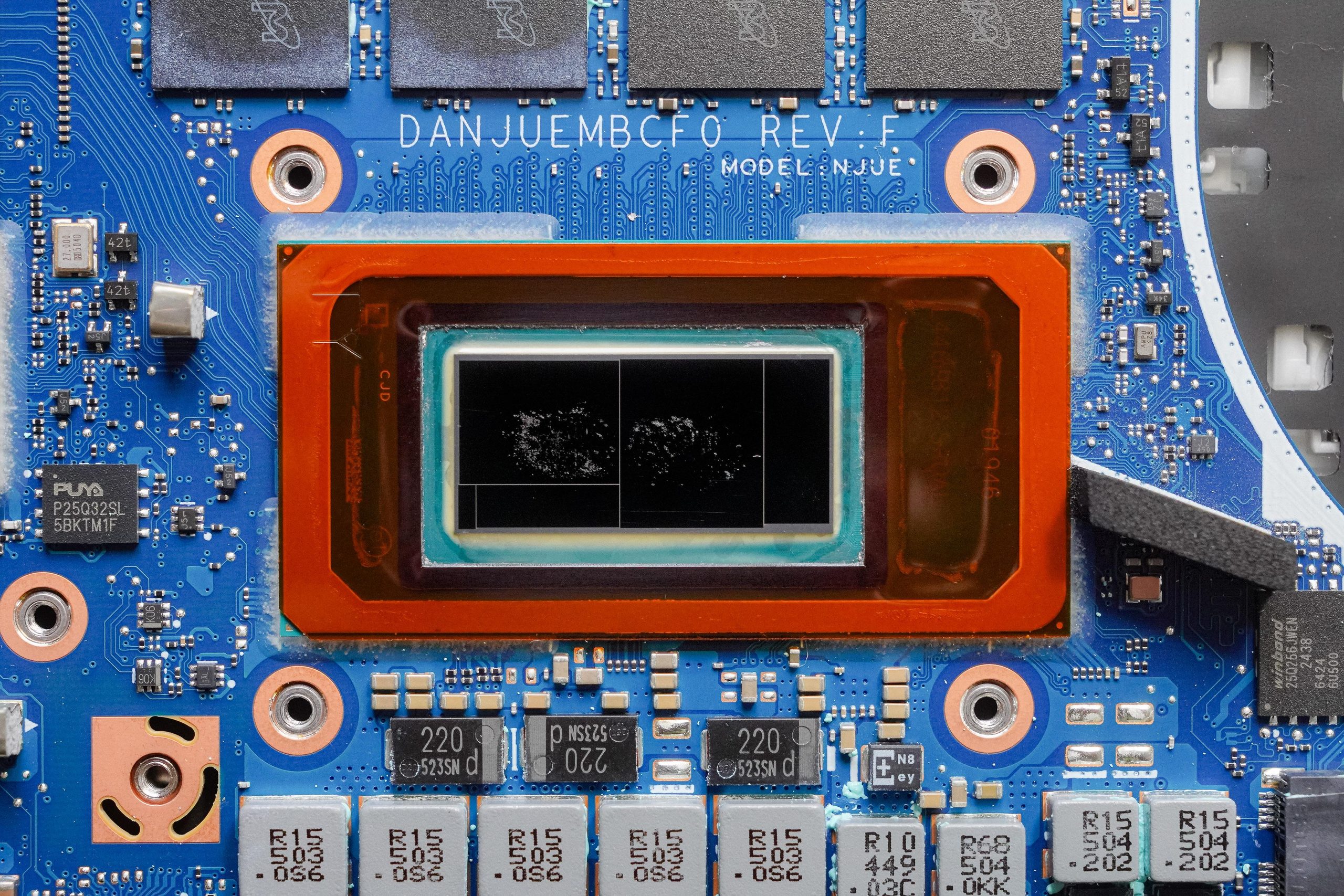 A close-up of an Intel CPU mounted on a blue circuit board labeled 'DANJUEMBCF0 REV. F' with various capacitors and components.