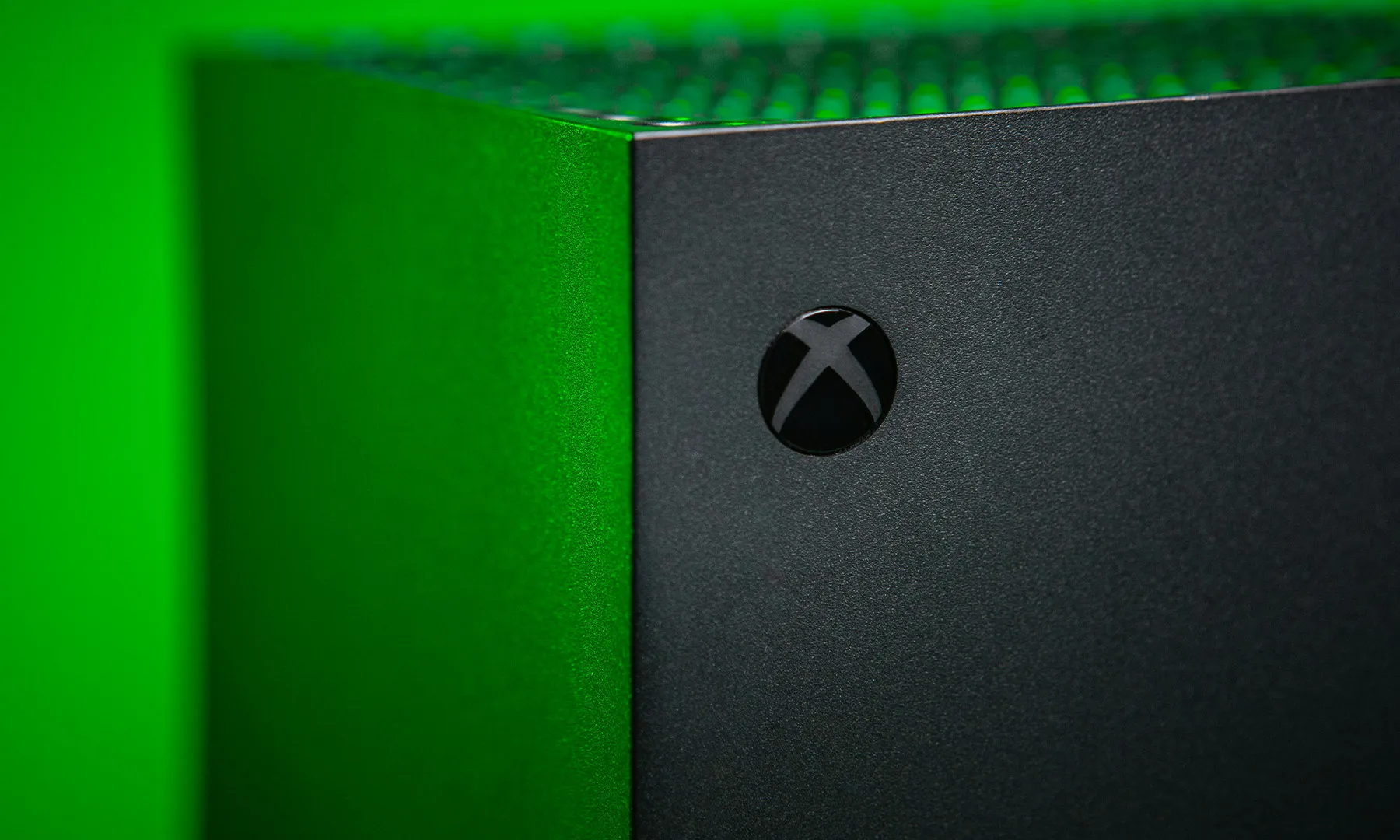 Xbox Series X in Green Light with focus on Xbox logo