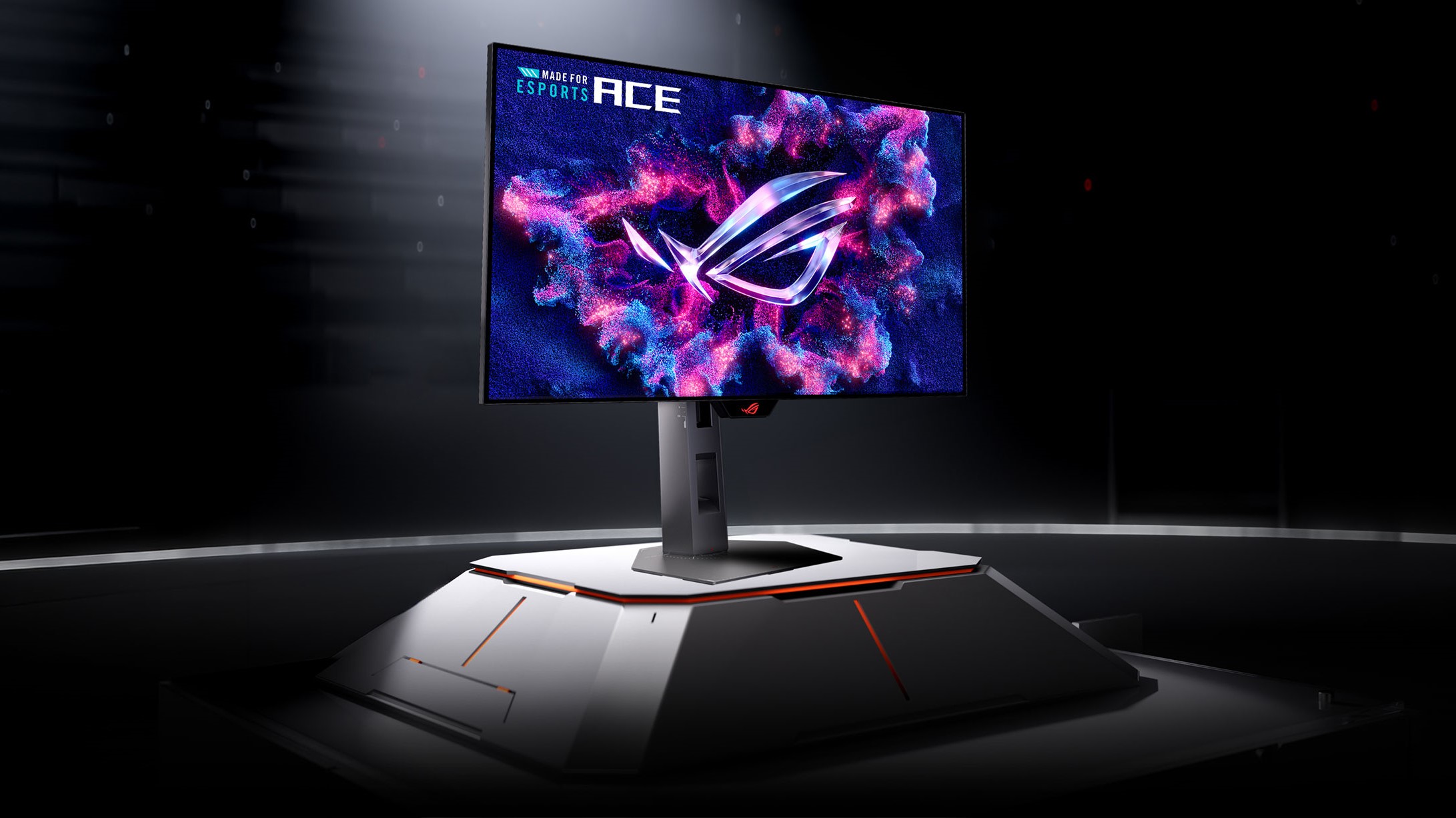 An ASUS ROG monitor displays vibrant colors with 'MADE FOR ESPORTS ACE' text on the screen, set on a futuristic pedestal in a dark setting.