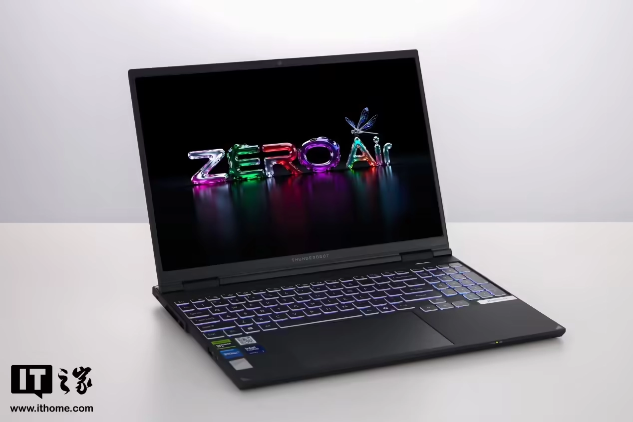 A ThundeRobot laptop displays colorful text 'ZERO Air' on its screen, positioned on a white surface.